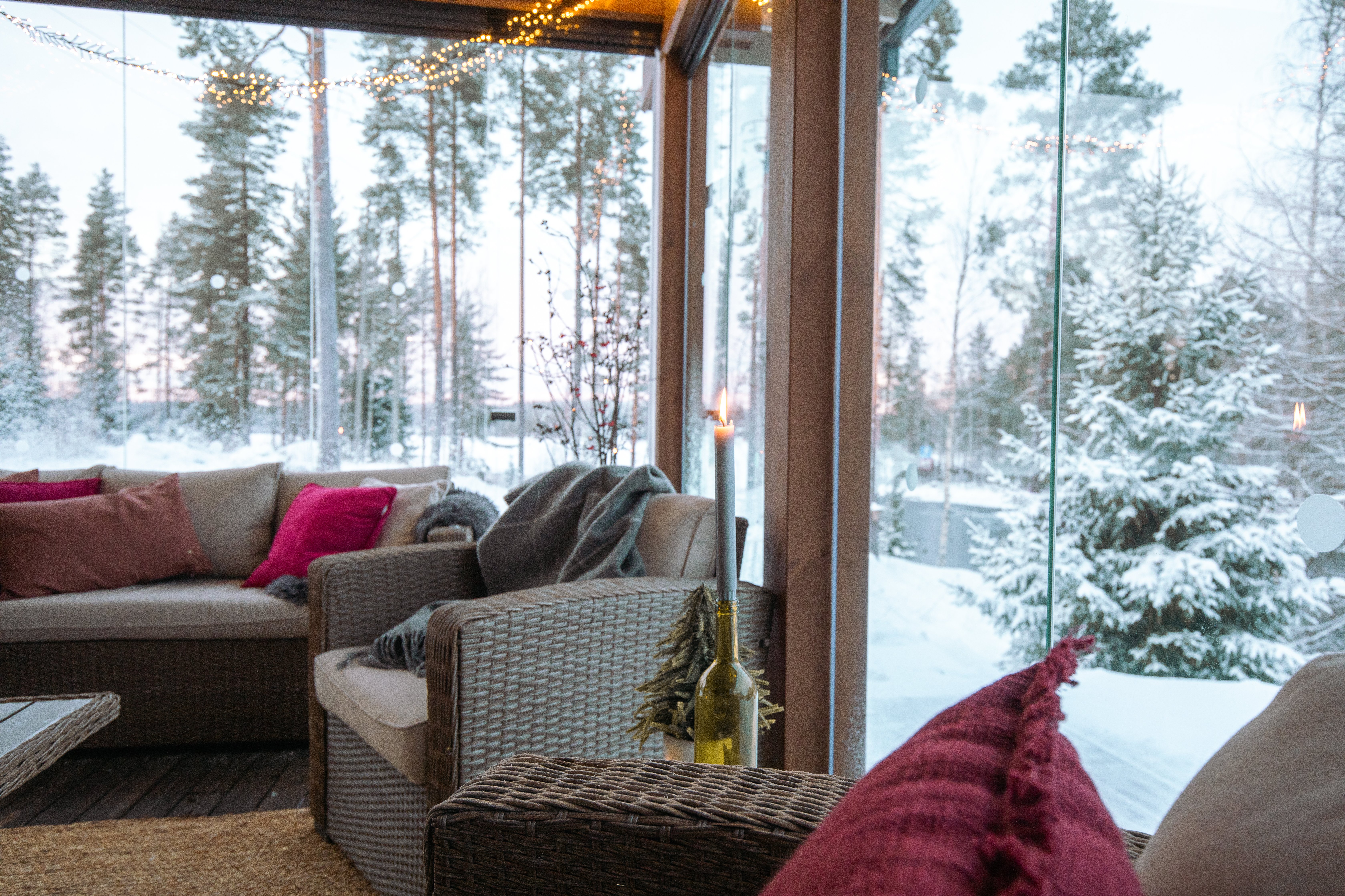 Cozy winter sunroom with snowy scenery in the back