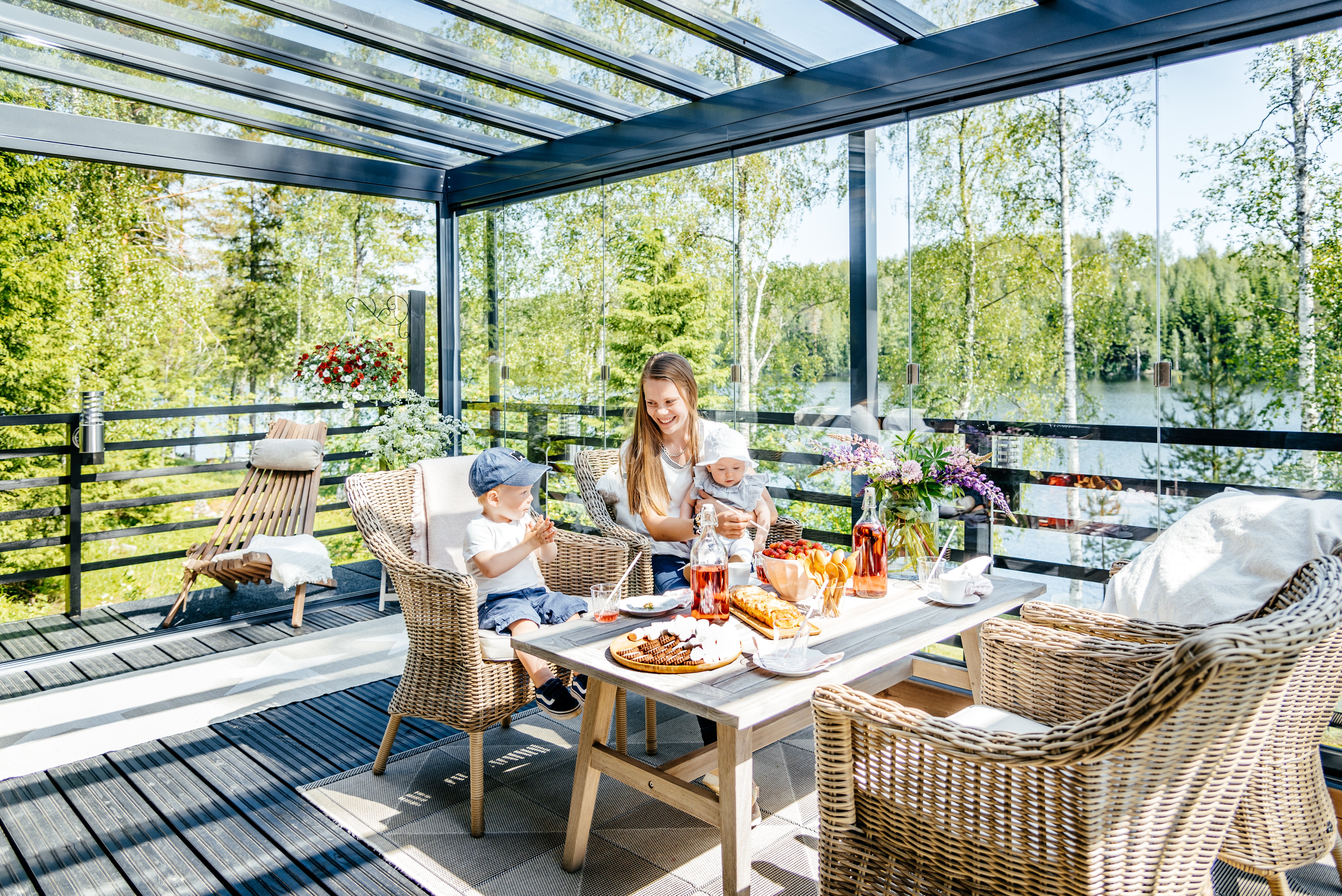 Glass sunroom on a sunny summer with family, surrounded by nature