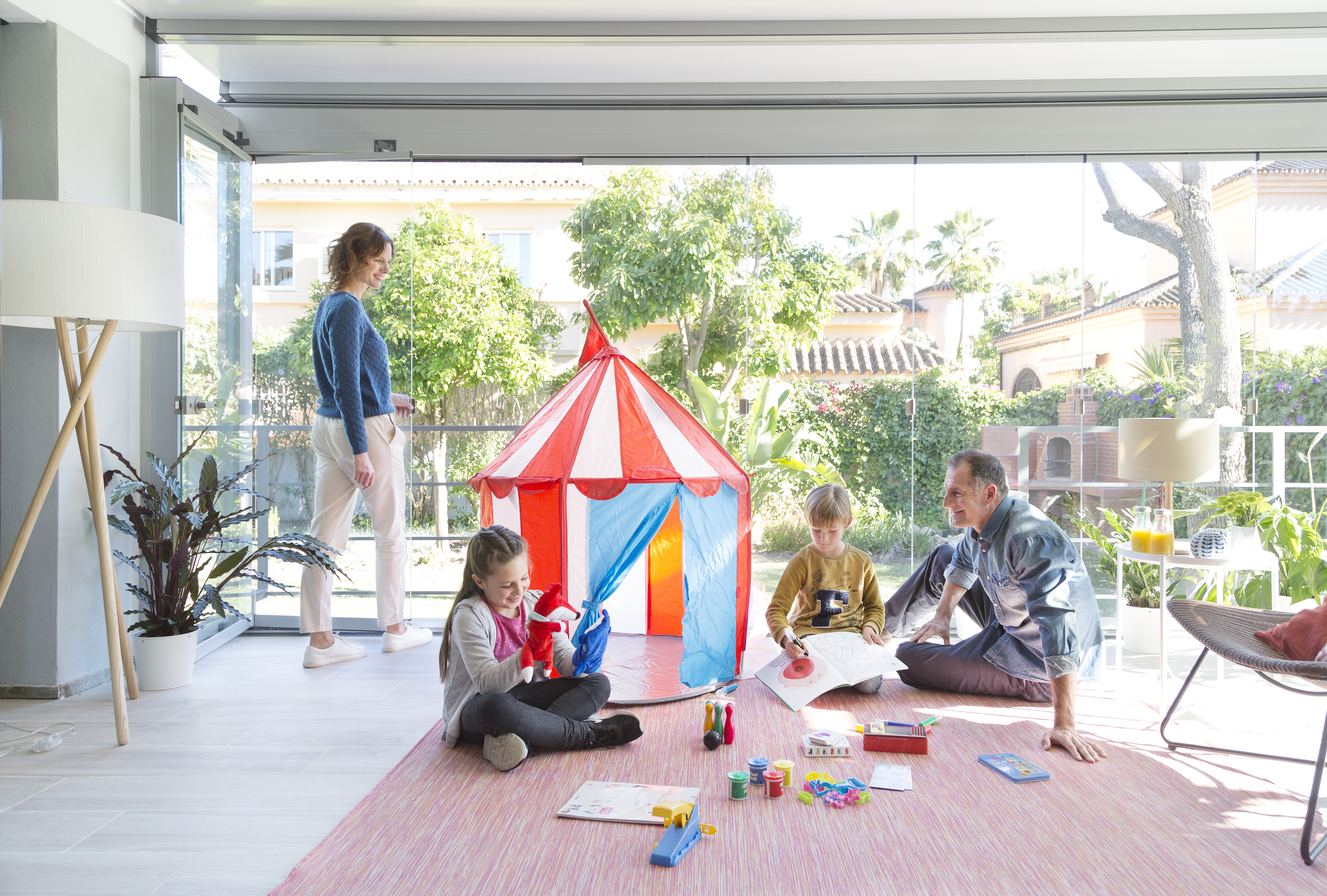 The sunroom is a safe indoor play area for your pets and children: children playing in sunroom
