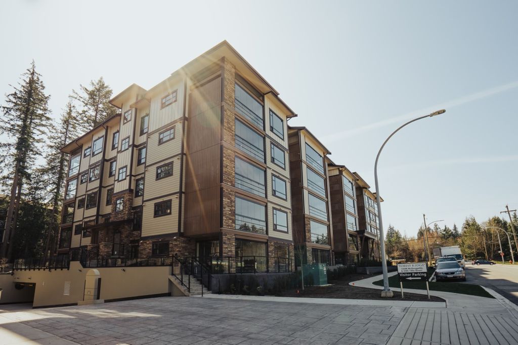 Condominium building in brown tones with glazed balconies